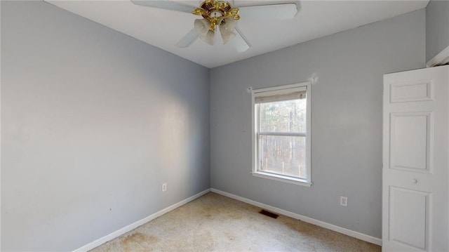 empty room with ceiling fan and carpet flooring