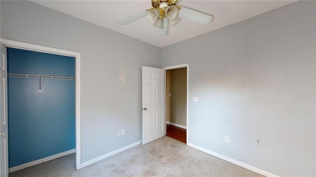 unfurnished bedroom with light carpet, ceiling fan, and a closet