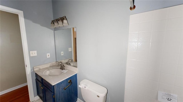 bathroom featuring vanity, hardwood / wood-style flooring, and toilet