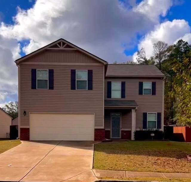 view of front of home featuring a garage and a front lawn