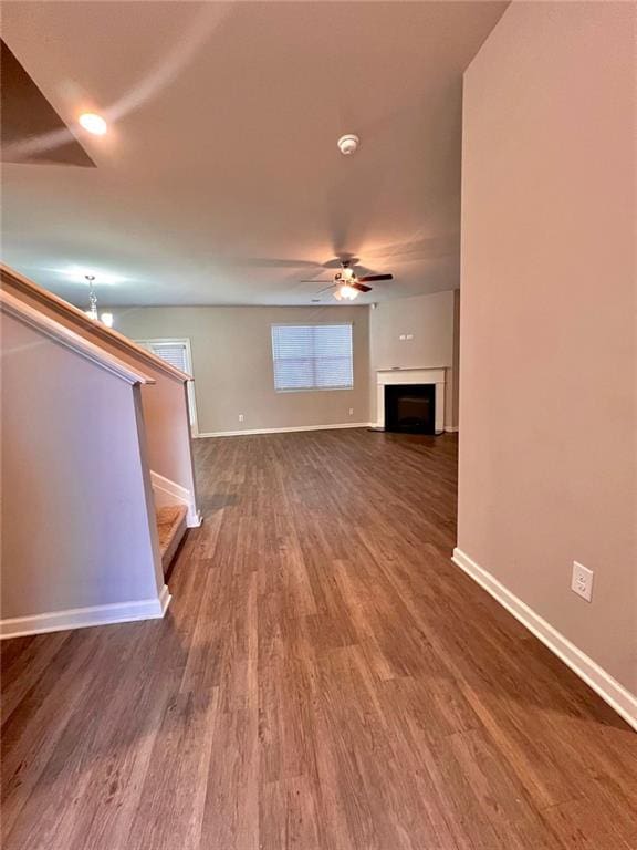 unfurnished living room with ceiling fan and wood-type flooring