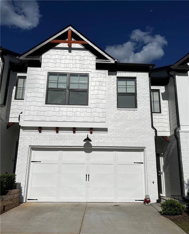 view of front of house with an attached garage and brick siding