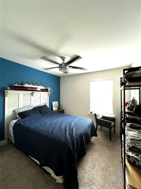 bedroom with ceiling fan and carpet flooring
