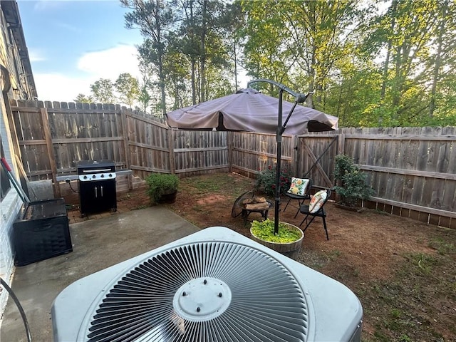 view of patio featuring central air condition unit, area for grilling, a fenced backyard, and a gate