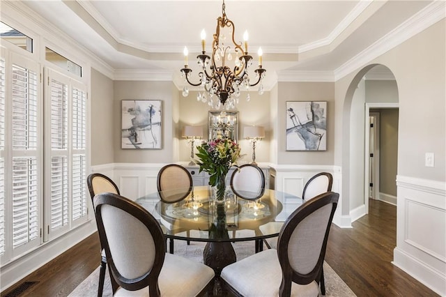 dining room with dark wood-style floors, a tray ceiling, and visible vents