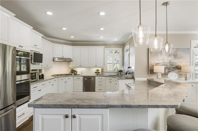 kitchen with appliances with stainless steel finishes, white cabinetry, and under cabinet range hood