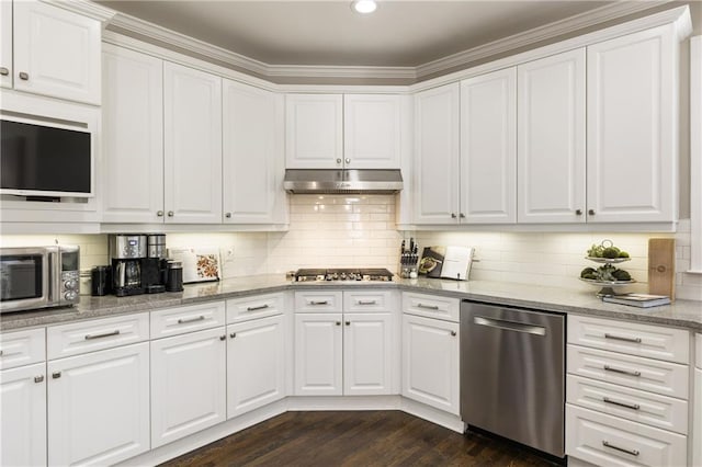 kitchen with dark wood-style floors, decorative backsplash, appliances with stainless steel finishes, white cabinetry, and under cabinet range hood