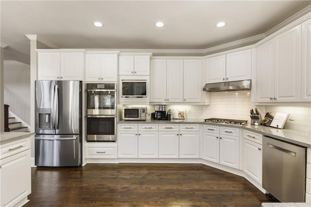 kitchen with light stone counters, dark wood-style floors, stainless steel appliances, white cabinets, and under cabinet range hood