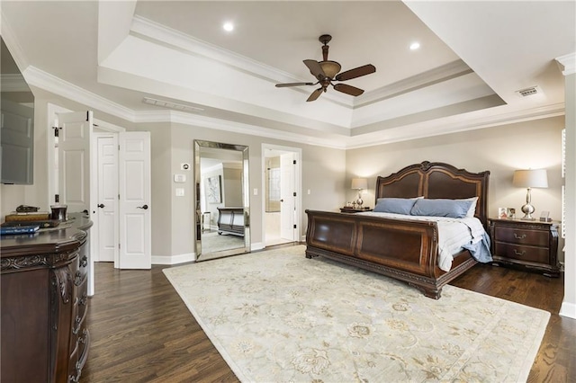 bedroom featuring ornamental molding, a tray ceiling, dark wood-type flooring, and visible vents