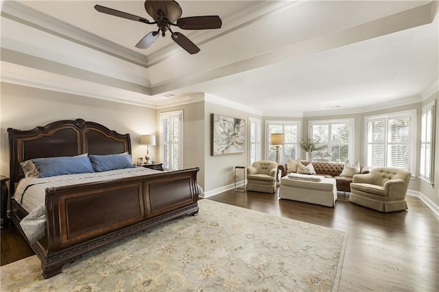 bedroom featuring baseboards, crown molding, and wood finished floors