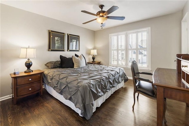 bedroom featuring dark wood-style floors, a ceiling fan, and baseboards