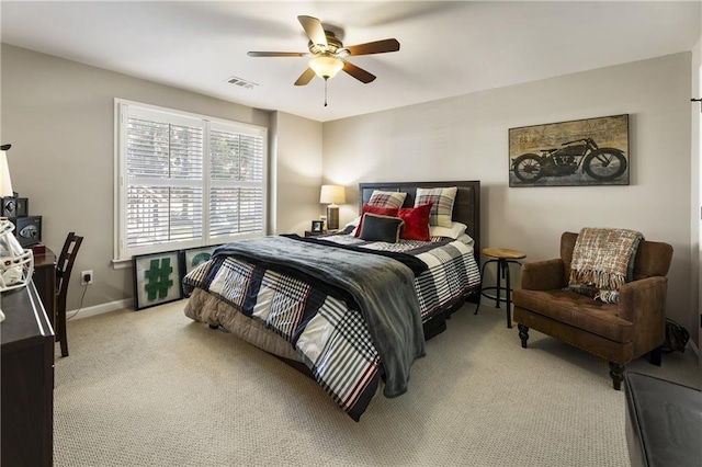 bedroom featuring light carpet, ceiling fan, visible vents, and baseboards