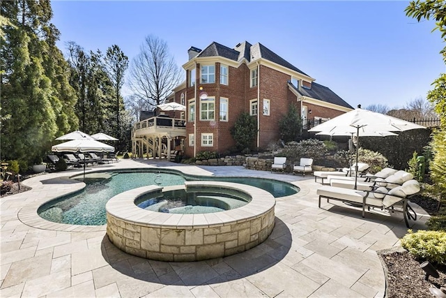 view of pool featuring a patio area and a pool with connected hot tub