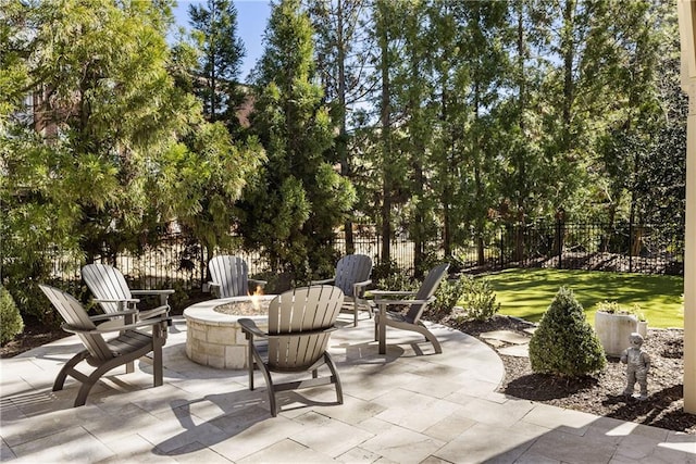 view of patio / terrace featuring an outdoor fire pit and fence