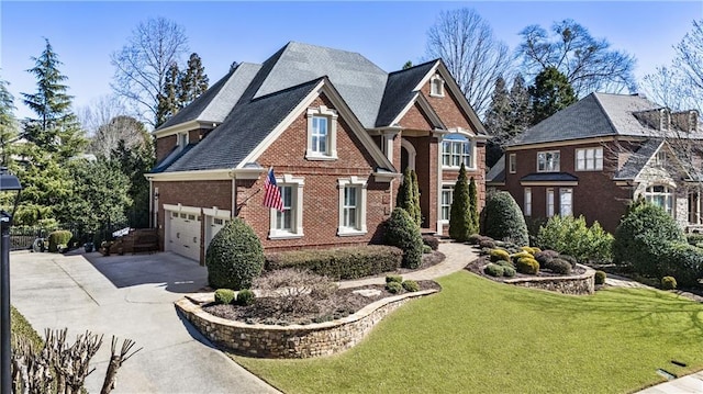 view of front of home with a front yard, brick siding, and driveway