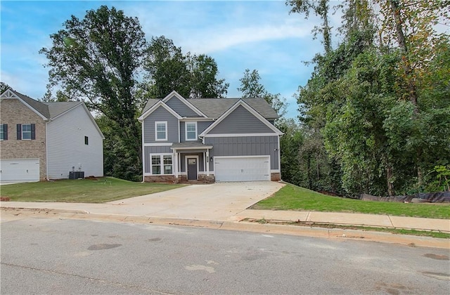 view of front of house with central AC, a front yard, and a garage