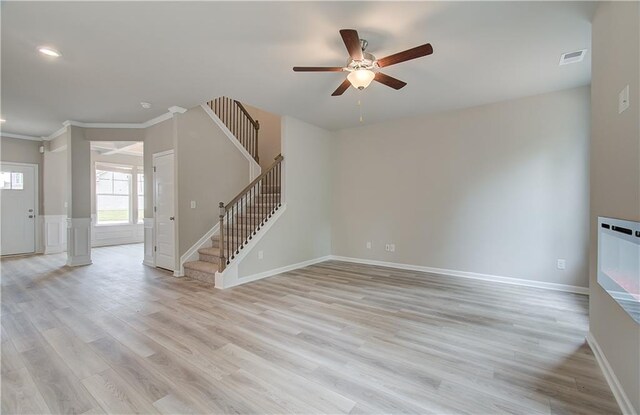 unfurnished living room featuring ceiling fan, light hardwood / wood-style flooring, and ornamental molding