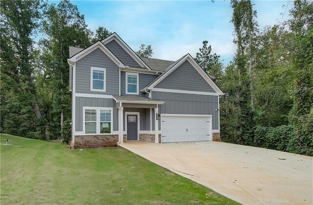 craftsman house featuring a front yard and a garage