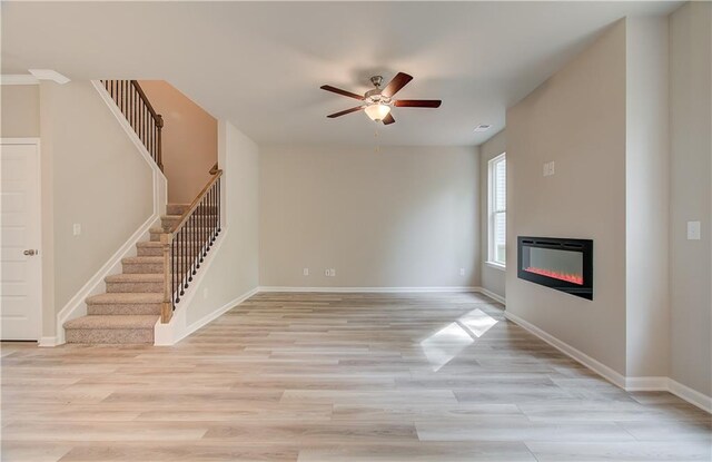 unfurnished living room featuring light hardwood / wood-style flooring and ceiling fan