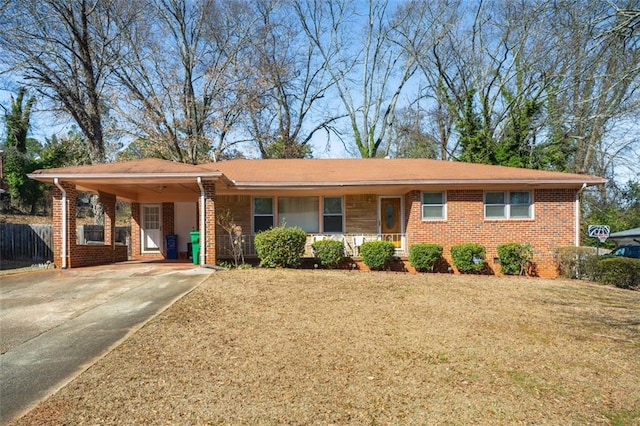 single story home featuring a carport, a front yard, brick siding, and driveway