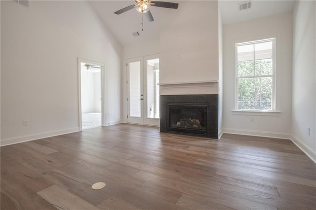 unfurnished living room featuring ceiling fan, high vaulted ceiling, french doors, and dark hardwood / wood-style flooring