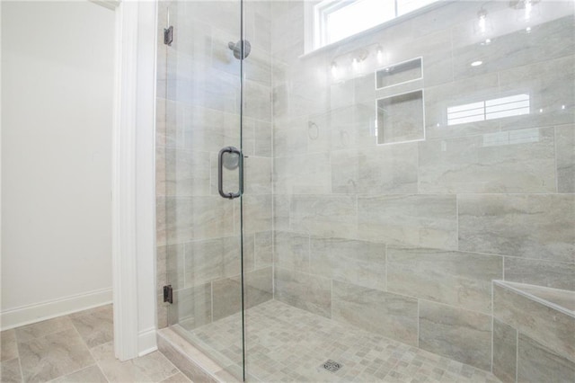 bathroom featuring tile patterned flooring and a shower with door