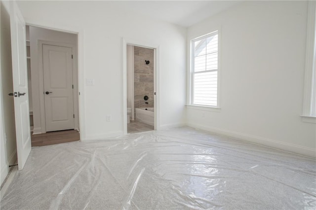 carpeted bedroom featuring connected bathroom