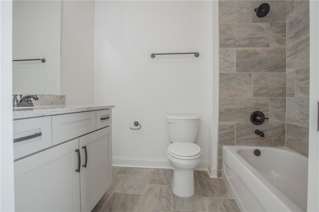 full bathroom with toilet, tiled shower / bath, vanity, and tile patterned floors