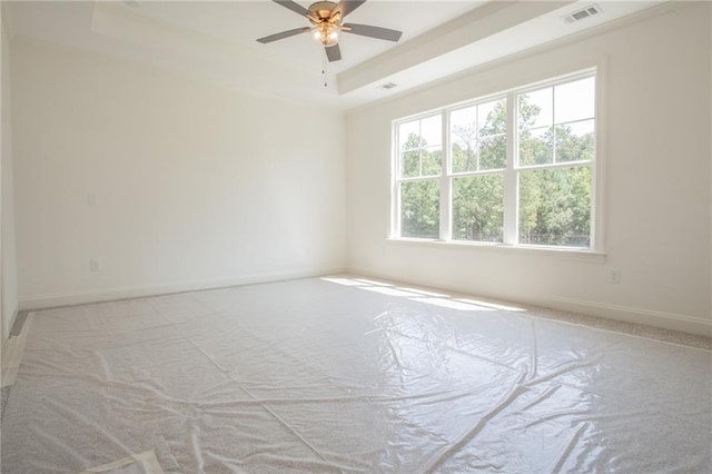 unfurnished room featuring ceiling fan and a tray ceiling