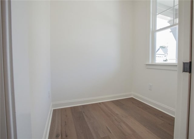 empty room with dark hardwood / wood-style flooring