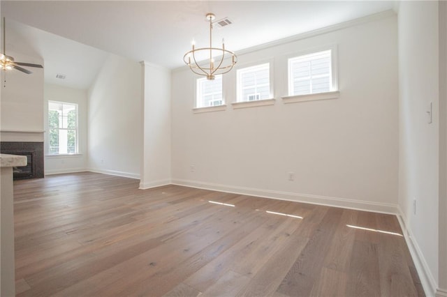 interior space featuring ceiling fan with notable chandelier, lofted ceiling, and hardwood / wood-style floors