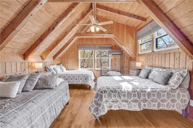 bedroom with wood walls and multiple windows