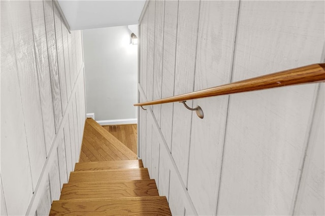 stairway featuring wood finished floors