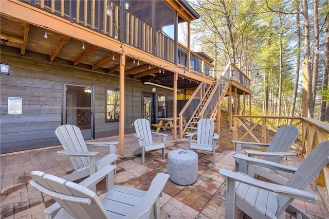 view of patio featuring a wooden deck and stairs