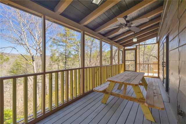 unfurnished sunroom with wooden ceiling, lofted ceiling with beams, and ceiling fan