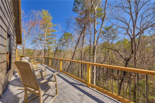 wooden deck featuring a view of trees