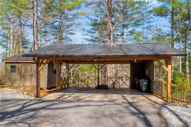 view of car parking featuring aphalt driveway and a detached carport