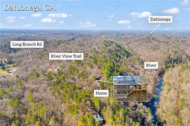 birds eye view of property with a wooded view