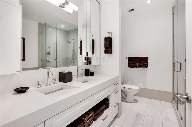 bathroom featuring tile patterned flooring, toilet, vanity, and walk in shower