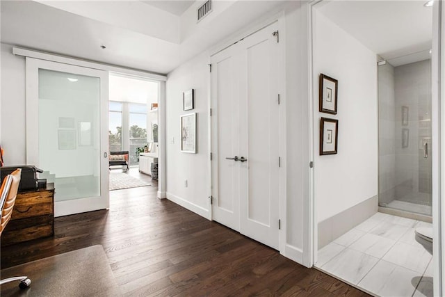 corridor with hardwood / wood-style floors