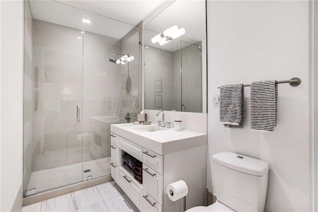 bathroom featuring vanity, a shower with shower door, tile patterned floors, and toilet