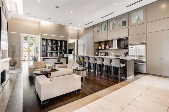 living room featuring a towering ceiling and tile patterned floors