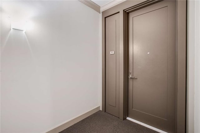 interior space with ornamental molding and dark colored carpet