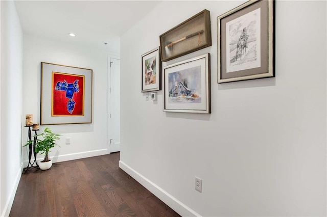 corridor with dark hardwood / wood-style flooring