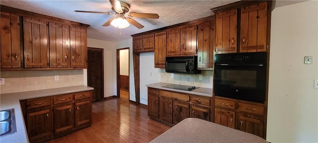 kitchen with black appliances, ceiling fan, decorative backsplash, wood finished floors, and a textured ceiling