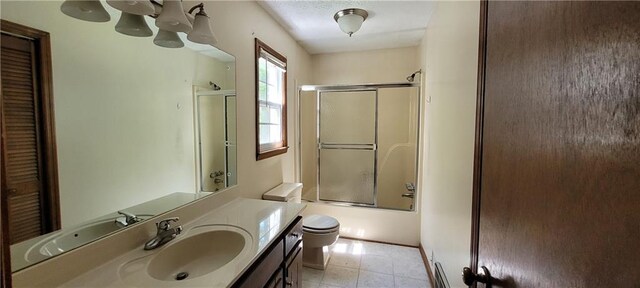 bathroom featuring vanity, toilet, bath / shower combo with glass door, and a chandelier