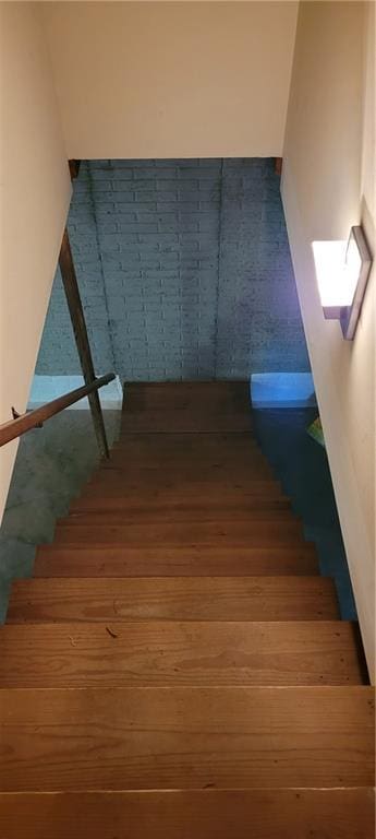 staircase featuring wood finished floors