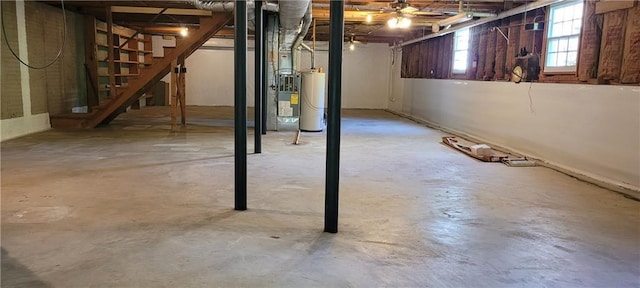 basement with water heater and stairway