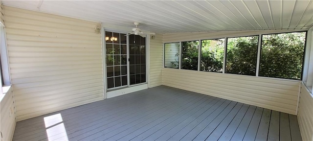 unfurnished sunroom featuring a ceiling fan