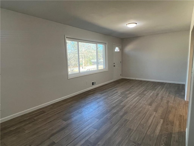 spare room with dark hardwood / wood-style flooring